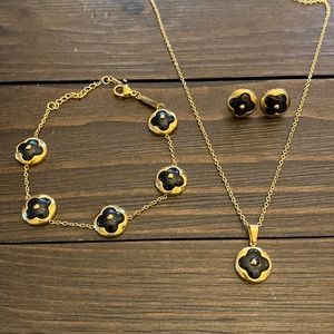 GOLD OVER STAINLESS STEEL WITH BLACK FOUR LEAF CLOVER